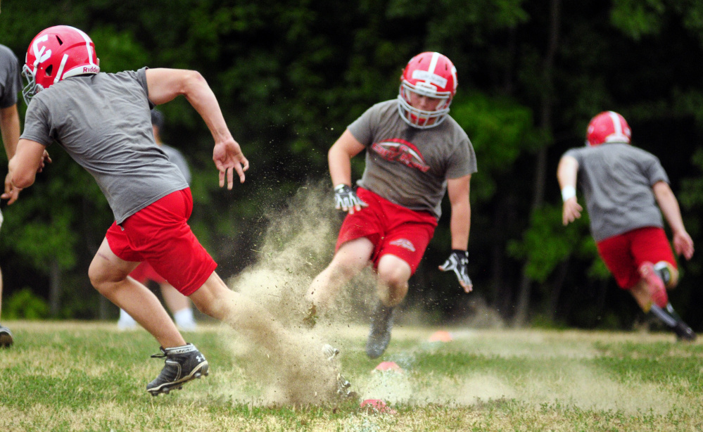 Dust flies as Cony linemen run agility drills during an Aug. 16 practic in Augusta.