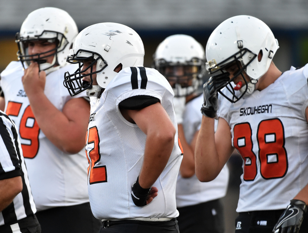 Skowhegan two-way tackle Owen Boardman, middle, takes a breather during a game against Lawrence last Friday.