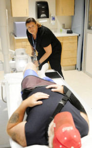 Radiology technician Melissa Denis, left, aims the machine to take a knee X-ray on veteran Galen Smith, of Lincoln, on Thursday in Building 200 the main hospital at the VA Maine Healthcare Systems-Togus.