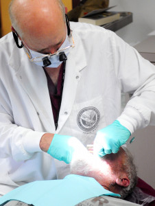 Dentist Mark Miedema works with veteran Daniel Ahern, of Biddeford, on Thursday in Building 200 the main hospital at the VA Maine Healthcare Systems-Togus.