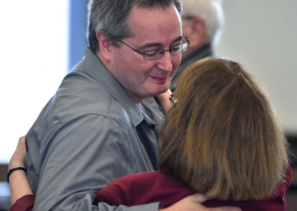 Dan Viles comforts his mother, Claudia, after her sentencing Sept. 2 at Somerset County Superior Court in Skowhegan.