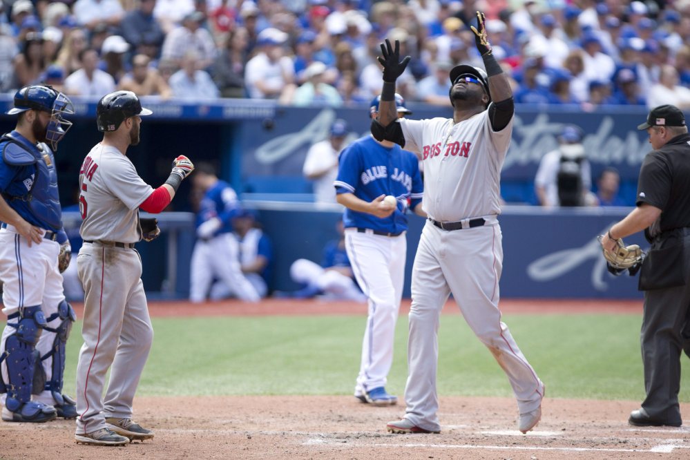 Boston Red Sox designated hitter David Ortiz (34) looks skyward following his three-run homer in the sixth inning against the Toronto Blue Jays on Sunday in Toronto.