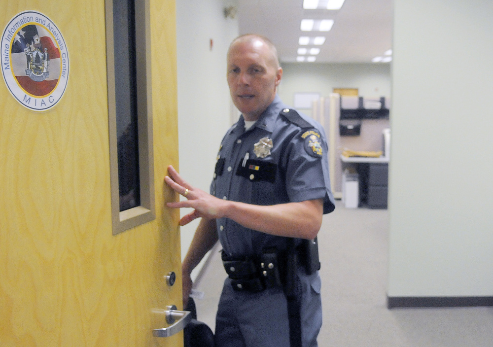 Lt. Scott Ireland opens the door to the Maine Information and Analysis Center at the Department of Public Safety in Augusta.