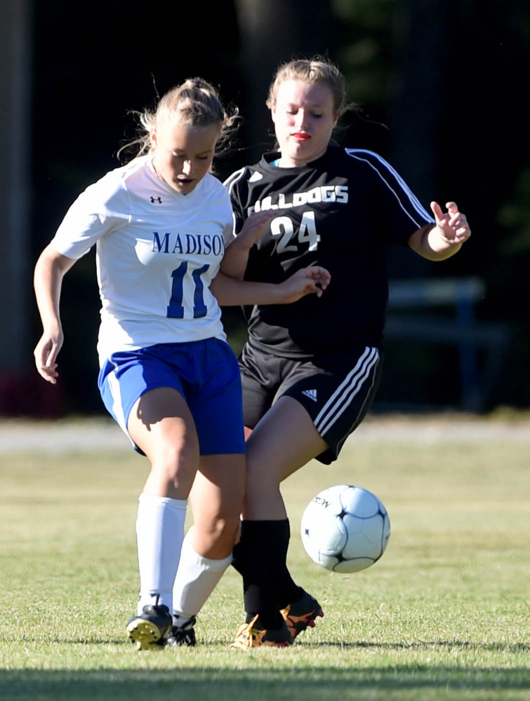 Madison junior Caitlyn Morgan (11) battles for the ball with Hall-Dale sophomore Kayla Searles during a Mountain Valley Conference game Tuesday afternoon. Madison won, 6-0.