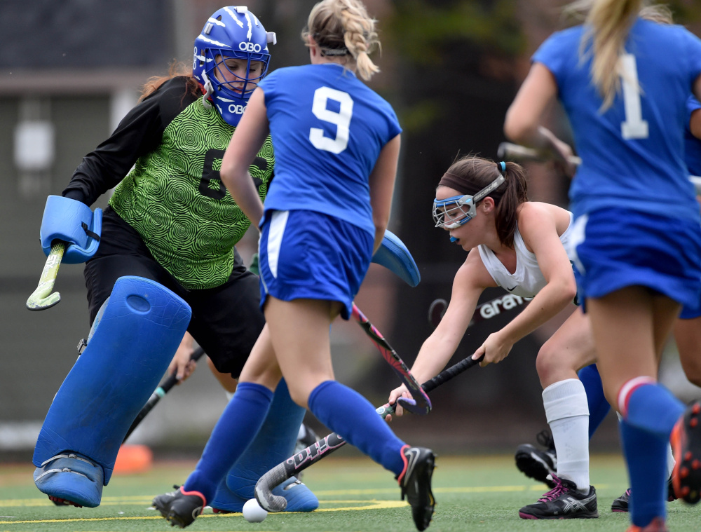 Winthrop sophomore Moriah Hajduk, right, tries to score on Oak Hill High School goalie Haley Salger during a Mountain Valley Conference game Wednesday at Thomas College in Waterville.