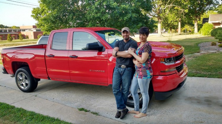 Valerie Tieman, right, is seen with her husband, Luc, in this July photo provided by police. Behind them is the truck she was last seen in Aug. 30 at a Wal-Mart parking lot in Skowhegan.