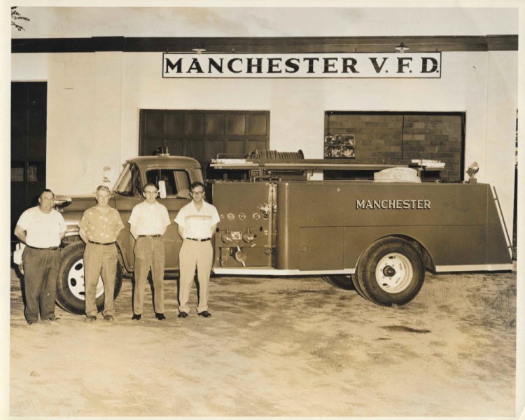 Albert Cummings, Curtis Berry, John Daggett and Ray Schrader pose in front of what was then a new firetruck in 1956.