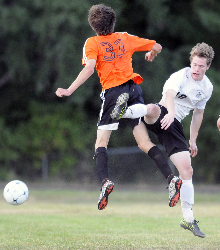 Maranacook's Max McQuillan, right, heads the ball as Winslow's Max Spaulding defends Thursday in Readfield.