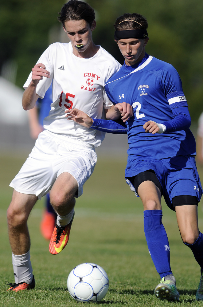 Cony's James Olivier, left, keeps the pressure on Messalonkee's Tanner Burton during a game Thursday in Augusta.