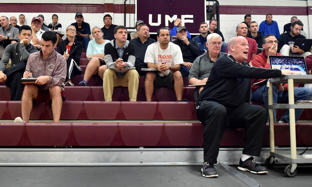 Steve Clifford, far right, head coach of the Charlotte Hornets, uses video for instruction during a coach's  basketball clinic Saturday at Dearborn Gymnasium in Farmington.