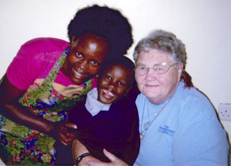 Betsy Drumm, right, is with the boy she sponsors, Arthur, 6, and a volunteer, Mary, in Kenya.