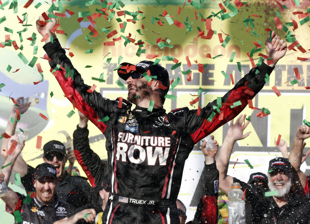 Martin Truex Jr., celebrates with his crew in Victory Lane after winning a NASCAR Sprint Cup Series race Sunday at Chicagoland Speedway in Joliet, Illinois.