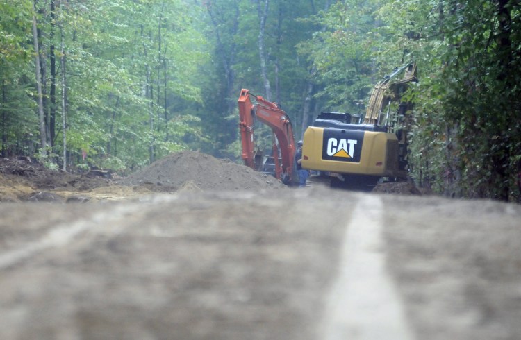 Excavators build a new road Monday at the Jamies Pond Wildlife Management Area in Manchester. Logging crews are harvesting wood at the 840 acre parcel of land managed by the Department of Inland Fisheries and Wildlife.
