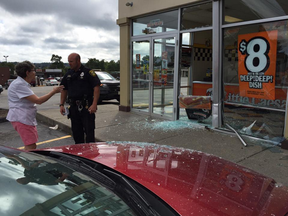 A photo posted on the Augusta Police Department's Facebook page shows the aftermath of a car crashing into the front entrance of Little Caesars pizza restaurant on Western Avenue in Augusta Tuesday morning.