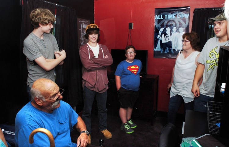 Surrounded by friends, Michael Welcome, center, said he was overwhelmed and loved his newly remodeled bedroom at his home in Madison on Tuesday. Welcome suffers from cystic fibrosis and received the new room through the Maine Make-A-Wish organization with help from Skowhegan Savings Bank. Welcome's father, Bill, is at left.