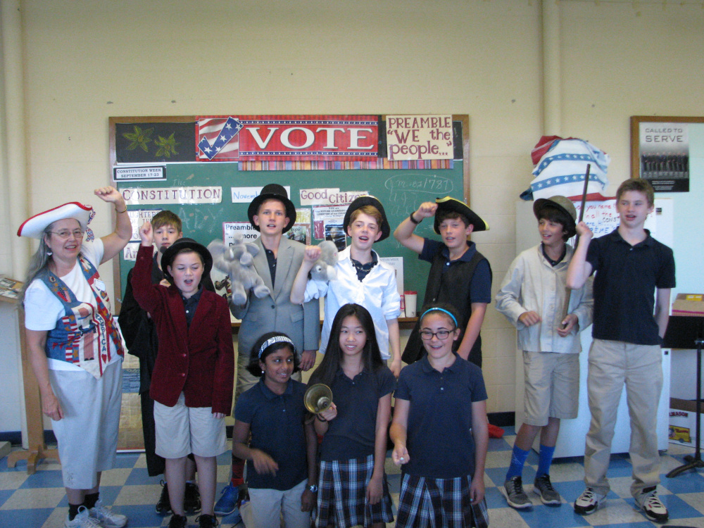 Students from St. Michael School in Augusta celebrated Constitution Week. Seventh graders cheer for the Red, White and Blue, in front, from left, are Andrew Rancourt, standing; and Amita Nanda, Grace Hodgkin and Madeleine MacDonald, all kneeling. In back, from left, are Constitution Lady Bonnie Wilder, Allen Weis, Oliver Sites, Samuel Flannery, Jake Varney, Jack Morrill and Kaleb Stred.