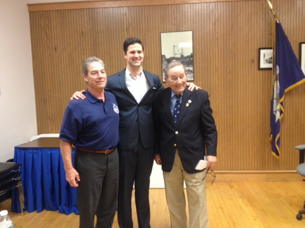 Longtime Waterville resident Paul Mitchell, right, stands with City Manager Michael Roy, left, and Mayor Nick Isgro at Tuesday's City Council meeting where Mitchell was honored for his many years of service to the city. The city's annual report for 2015-16 was dedicated to Mitchell, and he was given a copy of it Tuesday night.