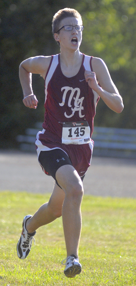 Monmouth Academy's Kyle Gunnells sprints to the finish line during a Mountain Valley Conference cross country meet Wednesday in Augusta.