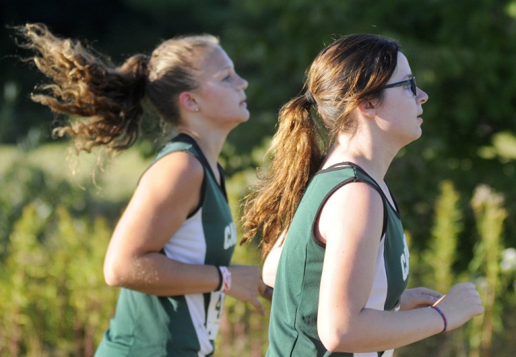 Carrabec High School's Samantha Taylor, right, and Nevaeh Burnham compete in a Mountain Valley Conference cross country meet Wednesday  in Augusta.