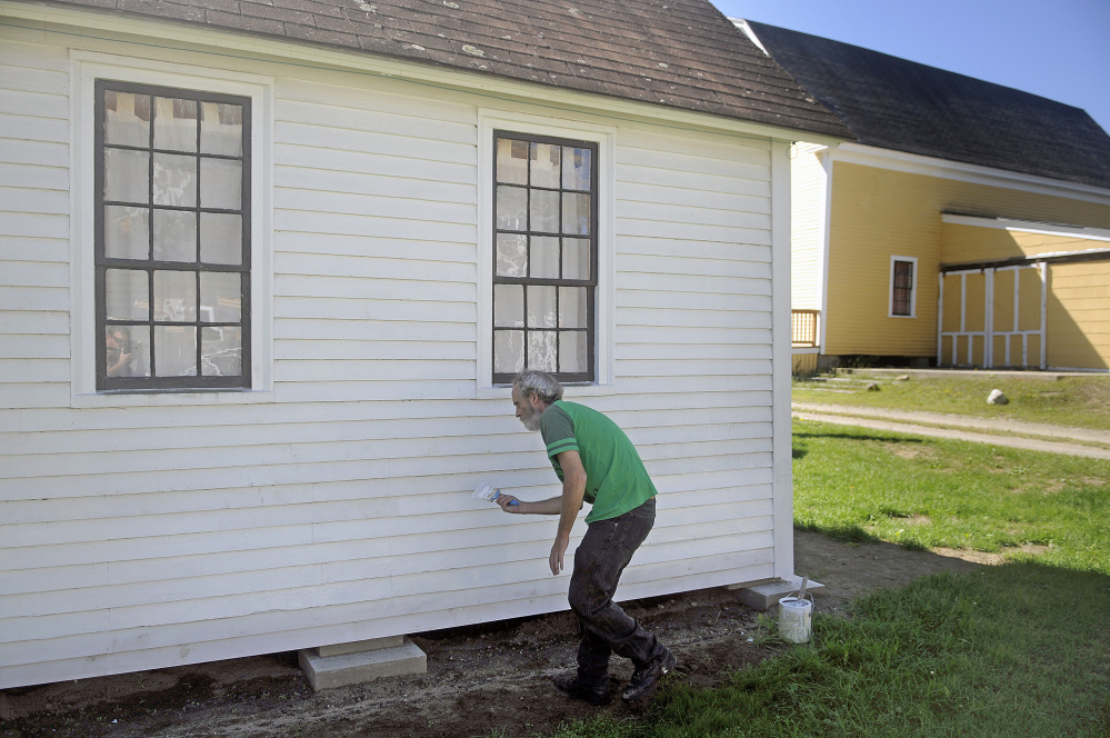 Colin McCabe paints the stencil shed at the Monmouth Museum in this Sept. 12, 2016 file photo. Volunteers are working diligently to prepare the structures and collections at the Museum for AppleFest on Saturday.