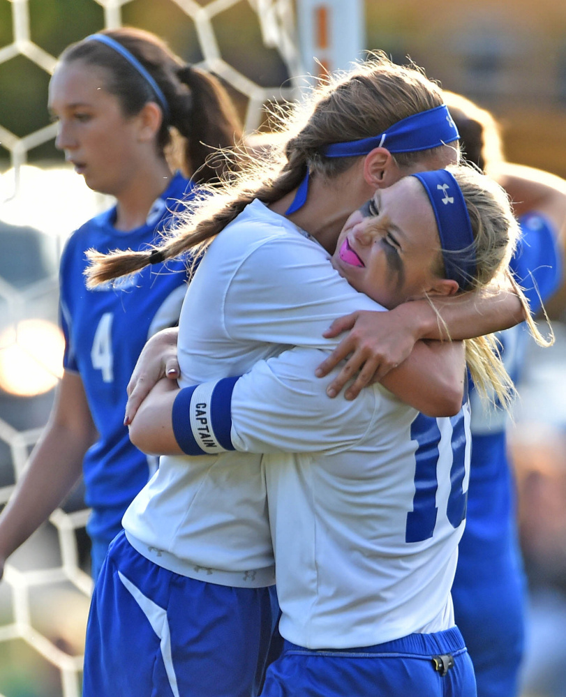 Madison Area Memorial High School's Madeline Wood (10) celebrates the only goal scored by teammate Sydney LeBlanc , left, against Oak Hill High School in Madison on Thursday. Madison defeated Oak Hill 1-0.