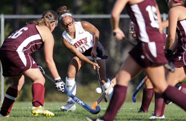 Cony's Kami Lambert passes through Edward Little's defense during a game Thursday in Augusta.