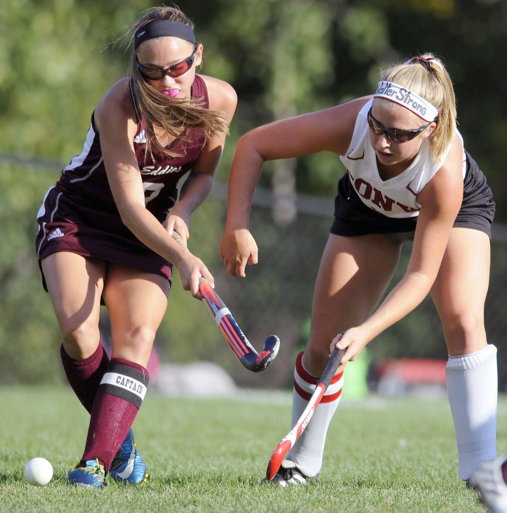 Cony's Delaney Keithley, right, passes around Edward Little's Kayla Vallee during a game Thursday in Augusta.