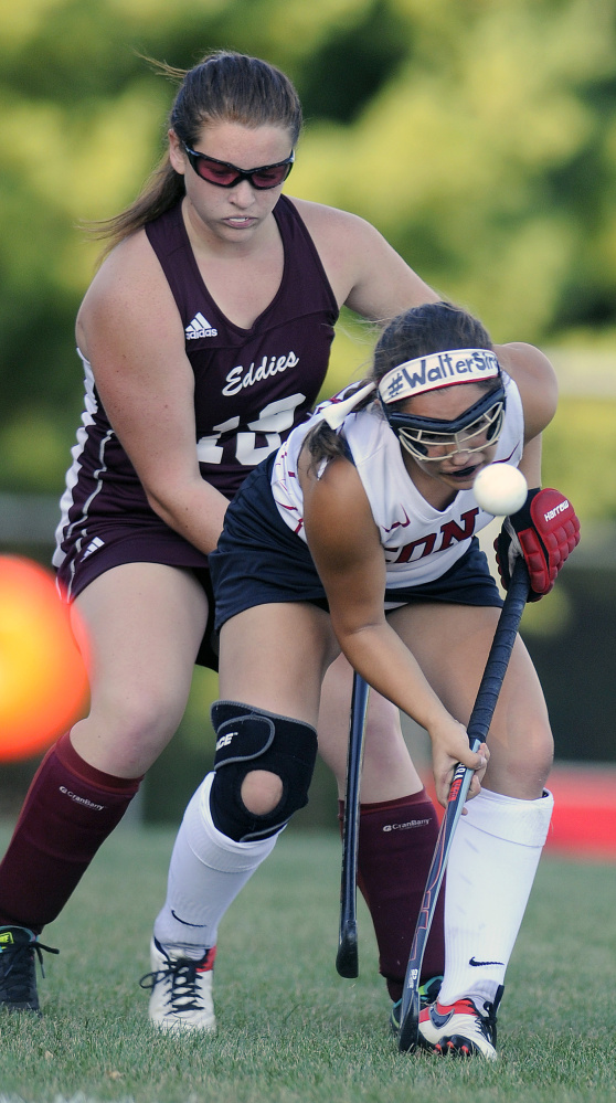 Cony's Danielle Brox, front, makes her way around Edward Little's Elizabeth Bellman during a game Thursday in Augusta.