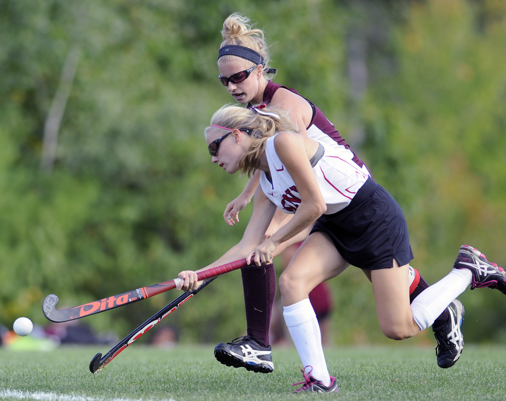 Cony's Sophie Whitney, front, drives past Edward Little's Grace McBride during a game Thursday in Augusta.