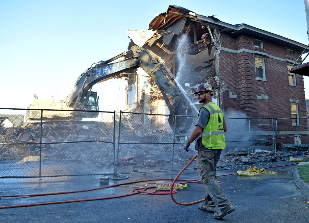 Construction crews with Costello Dismantling Company demolish the former Elks building on Appleton Street in Waterville on Sept. 13.