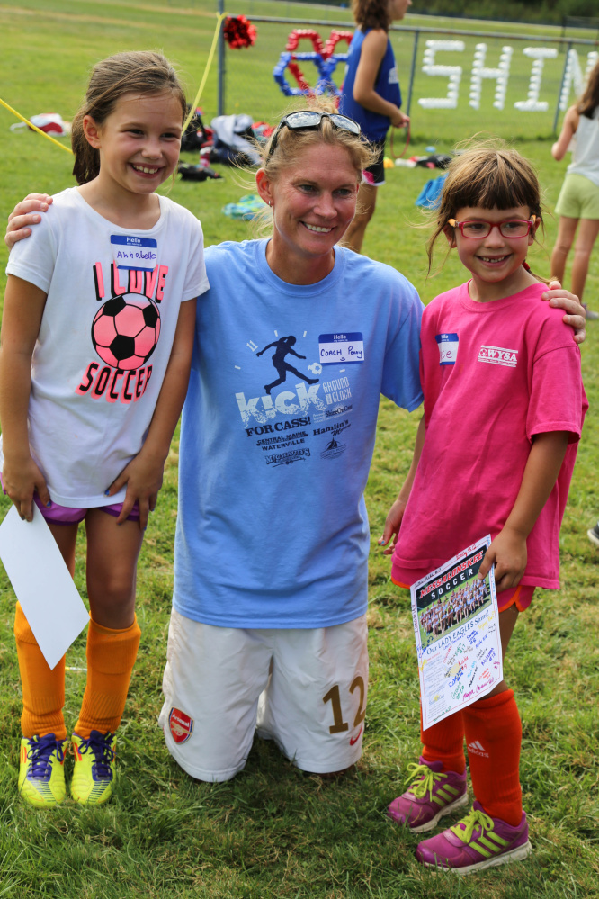 Penny Stansfield, Messalonskee High School girls' soccer coach, center, with two of her youngest fans, Annabell and Reese Hanscomb, who attended Shine On Saturday youth mentoring day at the Oakland high school.