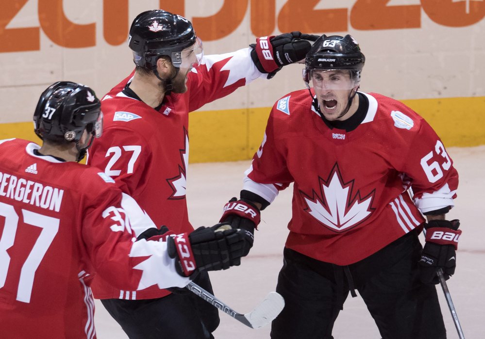 Team Canada center Brad Marchand (63) celebrates his game tying goal on Russia with teammates Alex Pietrangelo (27) and Patrice Bergeron (37)  during the second period of a World Cup of Hockey semifinal Saturday in Toronto.