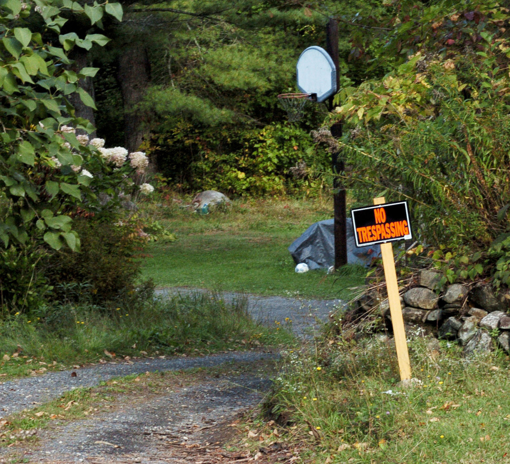 A "No Trespassing" sign is posted Tuesday in the driveway at the home of Alan and Laurelle Tieman on Norridgewock Road in Fairfield. Police found the body of their daughter-in-law, Valerie Tieman, partially buried on the property last week. The woman's husband, Luc Tieman, is charged with murder in connection with the killing.