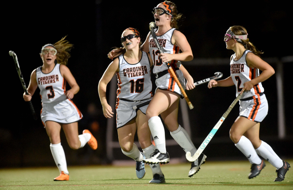 Gardiner's Hailee Lovely (13) celebrates her goal against Winslow with teammates Jillian Bisson (16), Madelin Walker (3) and Haley Brann, right, Tuesday at Thomas College in Waterville.