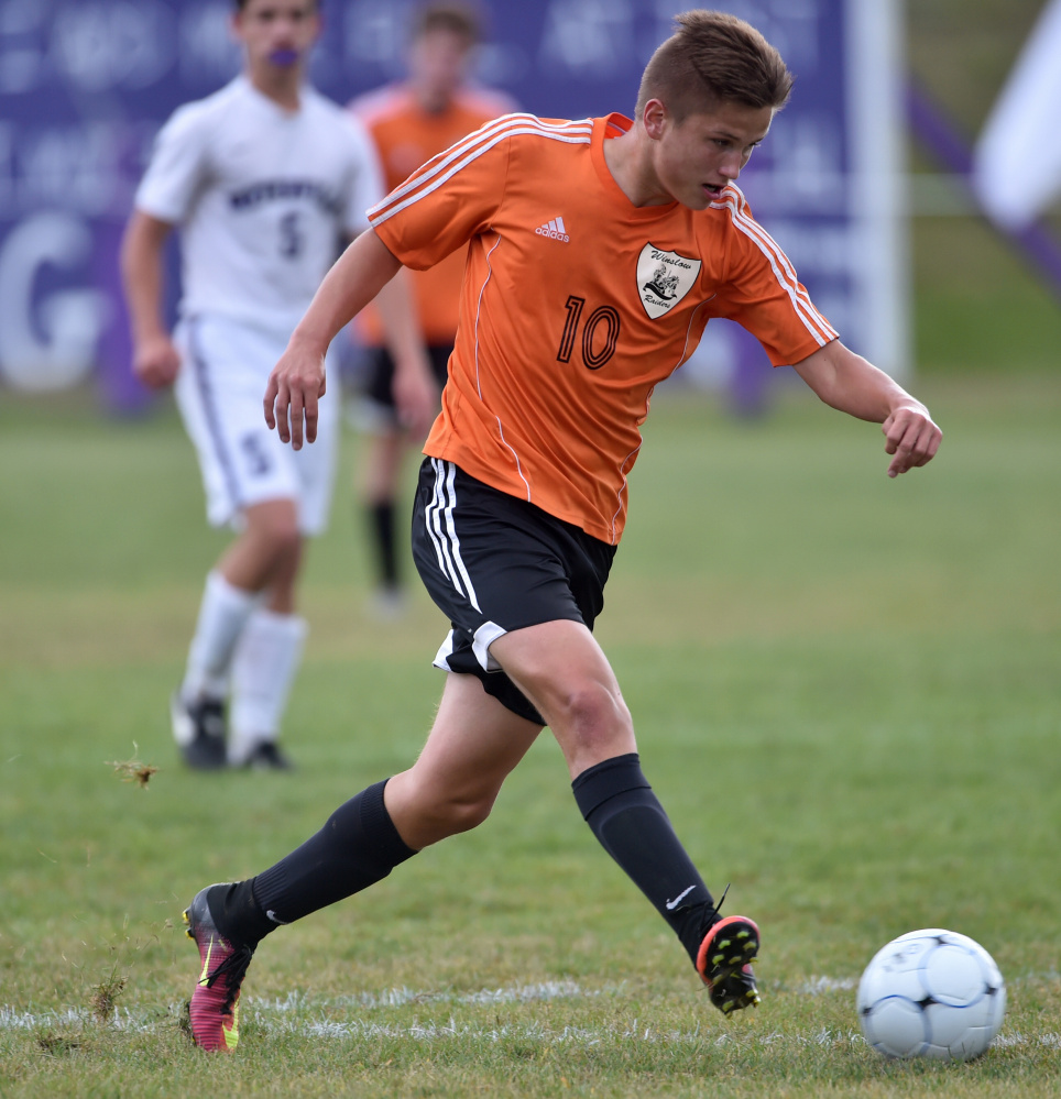 Winslow back Mike Wildes dribbles the ball down the field during a game against rival Waterville this season.