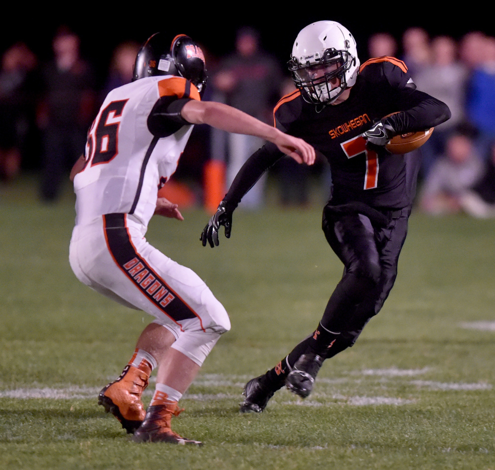 Skowhegan's John Bell (7) tries to avoid being Brunswick defender Donald Bromiley during a Pine Tree Conference Class B game Friday night in Skowhegan.