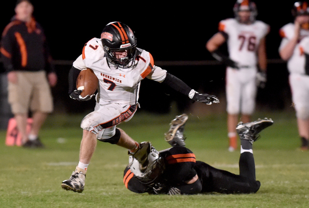 Brunswick senior Jesse Devereaux, left, evades Skowhegan defender Devin Dressler during a Pine Tree Conference Class B game Friday night in Skowhegan.