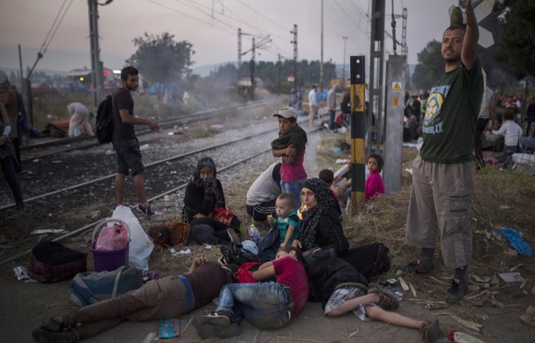 Syrian refugees wait near a Greek rail station in December 2015.