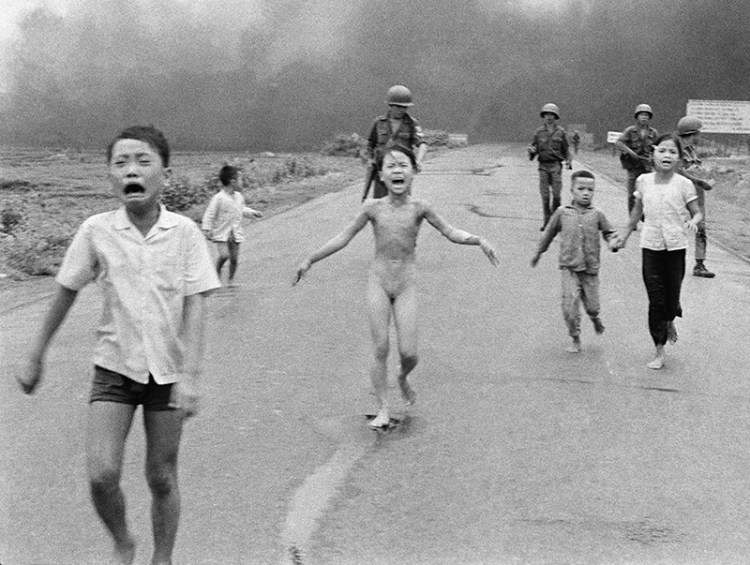 The  June 8, 1972 file photo of South Vietnamese forces following terrified children, including 9-year-old Kim Phuc, center, as they run near Trang Bang after an aerial napalm attack.