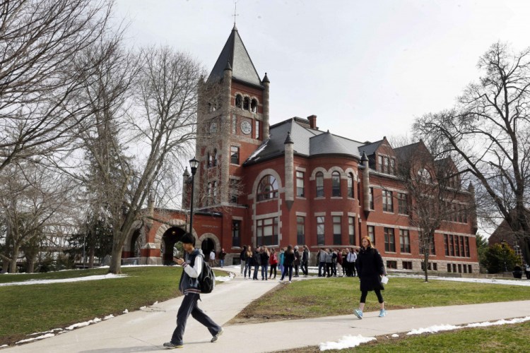 Students walk past Thompson Hall at the University of New Hampshire in Durham in April 2016. 