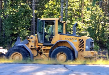 A stolen front-end loader sits on the side of the Maine Turnpike after it hit several cars on Monday morning. Photo by WCSH-TV