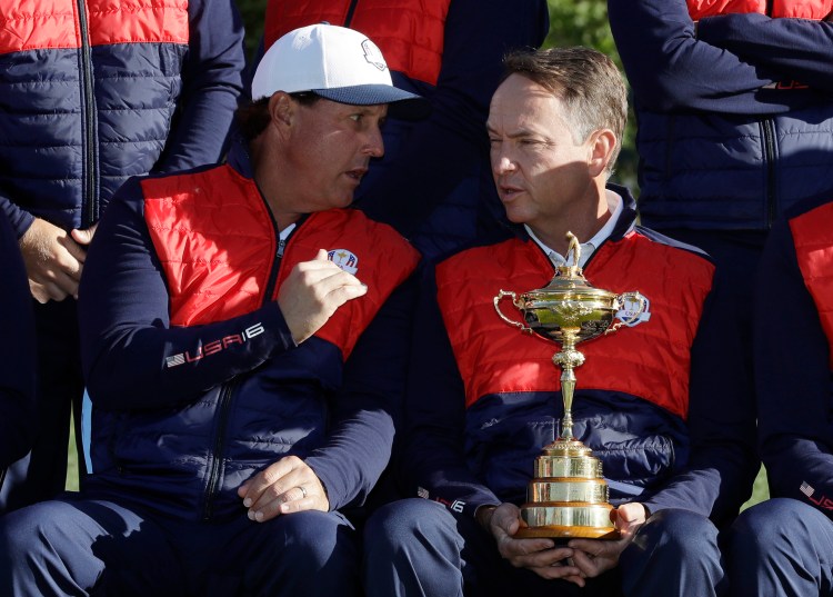 U.S. Davis Love III, right, talks to Phil Mickelson during a team photo  Tuesday. Love's comments on a radio show last week provided some bulletin board material for the European team.   Associated press/David J. Phillip