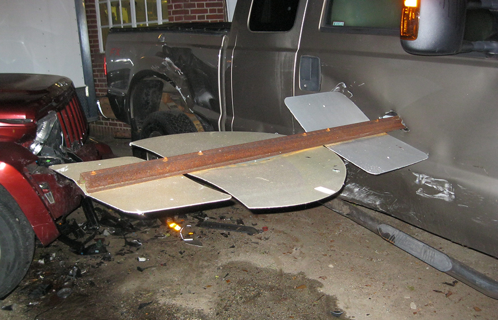 A road sign protrudes from the side of a pickup truck after a crash at Reed's. <em>Photo courtesy of Yarmouth Police Department</em>
 