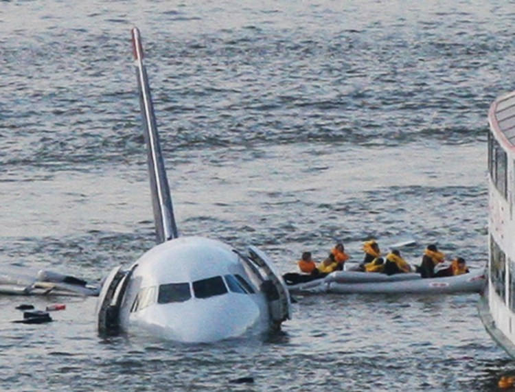 In this 2009 file photo, passengers in an inflatable raft move away from an Airbus 320 US Airways aircraft that went gone down in the Hudson River in New York. 