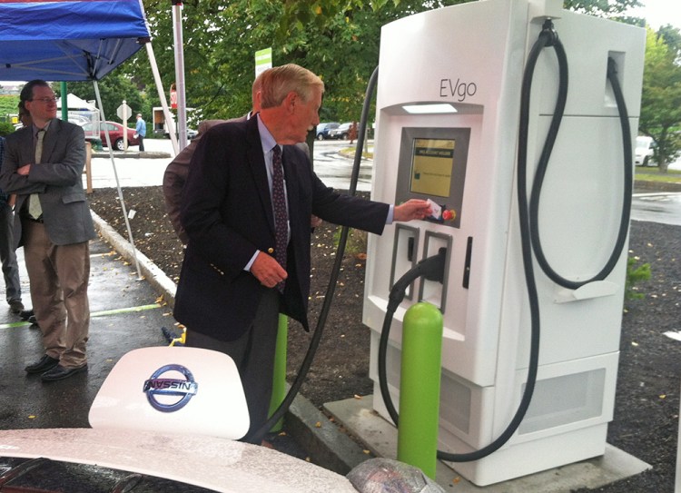 Sen. Angus King uses a high-speed charging kiosk Friday at the Forest Avenue Hannaford store in Portland. He says electric transportation powered by renewable energy is essential to cut greenhouse gas emissions and curb the effects of climate change.