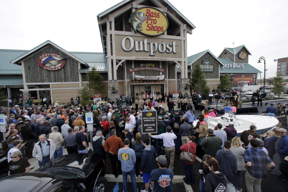 A large crowd of people line up as they wait for the grand opening of Bass Pro Shops Outpost store in Atlantic City, N.J.