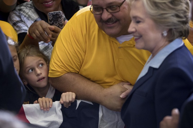 A girl gazes at Democratic presidential candidate Hillary Clinton as she greets members of the audience at a rally at the Downtown Toledo Train Station in Toledo, Ohio, on Monday.