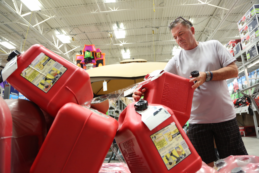 Jim LaFeir, of Ft. Lauderdale, buys a gas can at Lowe's in Oakland Park, Fla., on Tuesday. Anxious Florida residents emptied grocery store shelves and North Carolina called for the evacuation of three barrier islands as Hurricane Matthew, the most powerful Atlantic storm in a about decade, threatened to rake a large swath of the East Coast in the coming days.