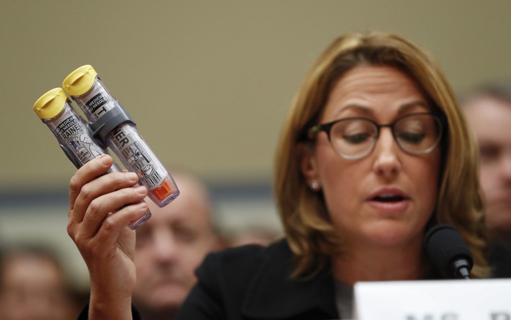 Mylan CEO Heather Bresch holds EpiPens while testifying in Washington on Sept. 21. The Justice Department alleged that the company overbilled Medicaid.
Associated Press/Pablo Martinez Monsivais