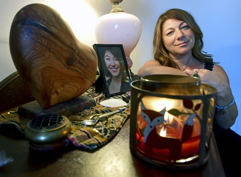 Donna Cimarelli, mother of murdered Maren Sanchez, sits next to a small memorial for her daughter that includes a heart shaped urn that holds Maren's ashes in her home in Milford, Conn. Maren Sanchez was killed by a high school classmate in April 2014.